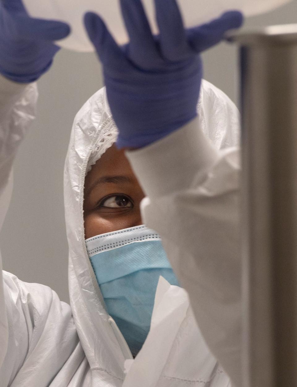 An employee at the Afrigen biotechnology company and Vaccine Hub facility, works in the manufacturing laboratory in Cape Town, on October 05, 2021 (AFP via Getty Images)