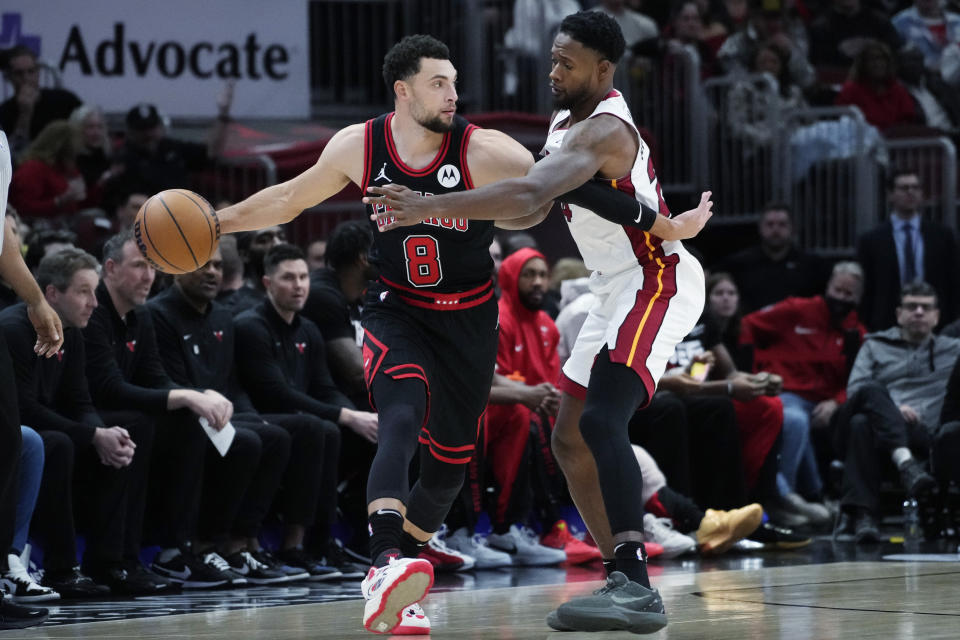 Chicago Bulls guard Zach LaVine, left, looks to pass the ball as Miami Heat forward Haywood Highsmith guards during the first half of an NBA basketball game in Chicago, Saturday, Nov. 18, 2023. (AP Photo/Nam Y. Huh)