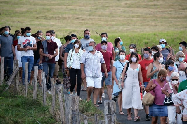 People wear face masks as they leave a music festival in Saint Etienne de Baigorry, southwestern France