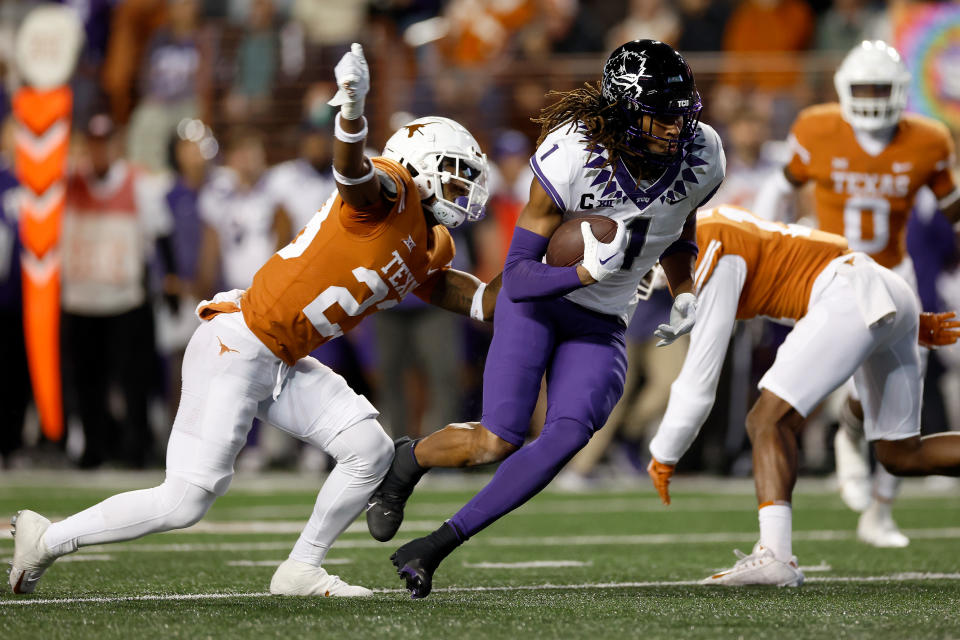 TCU wide receiver Quentin Johnston runs after a catch against Texas while defender Jahdae Barron chases him on November 12, 2022 in Austin, Texas. (Photo by Tim Warner/Getty Images)