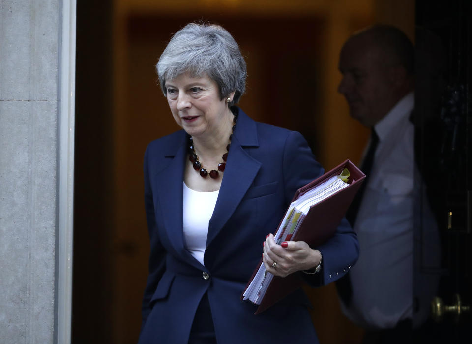 British Prime Minister Theresa May leaves 10 Downing Street heading to Parliament for Prime Minister's questions in London, Wednesday, Nov. 14, 2018. May will try to persuade her divided Cabinet on Wednesday that they have a choice between backing a draft Brexit deal with the European Union or plunging the U.K. into political and economic uncertainty. (AP Photo/Matt Dunham)