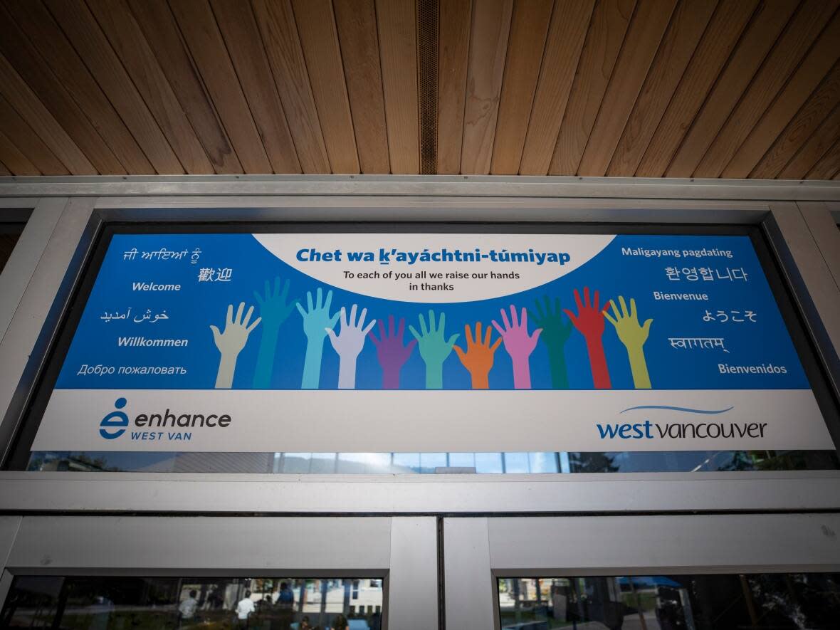 Multilingual welcome signs are pictured at the entrance of a community centre in West Vancouver. The latest census data shows a growing number of British Columbians speak languages other than Indigenous languages, English and French as their native tongue. (Ben Nelms/CBC - image credit)