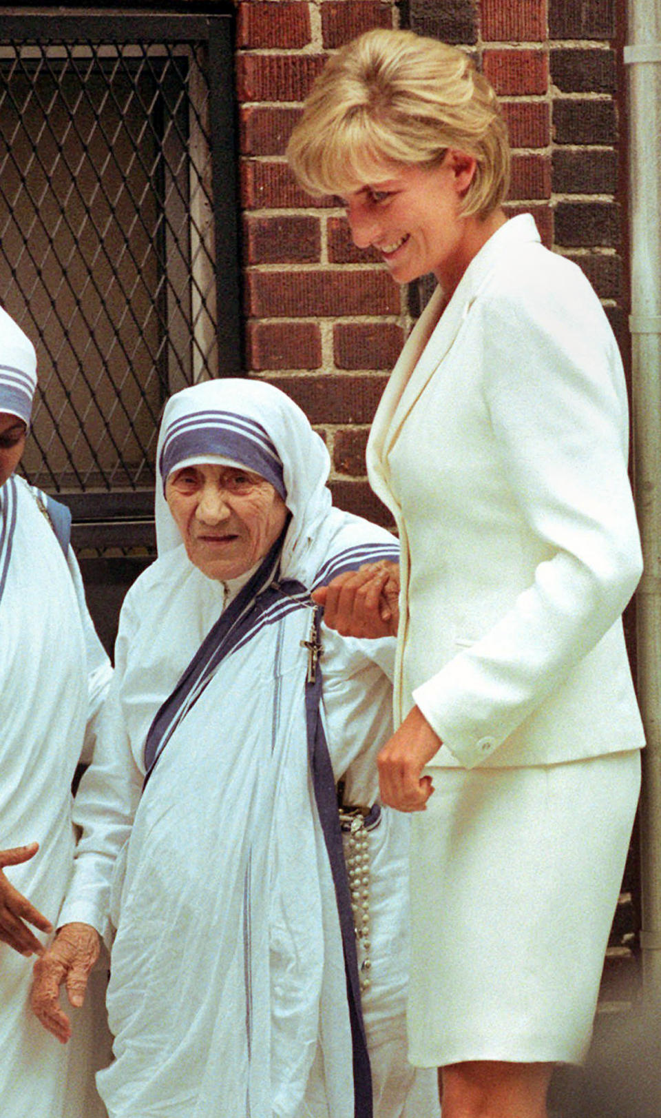 FILE - Mother Teresa, left, walks with Diana, Princess of Wales, after receiving a visit from her June 18, 1997, in New York. (AP Photo/Bebeto Matthews, File)