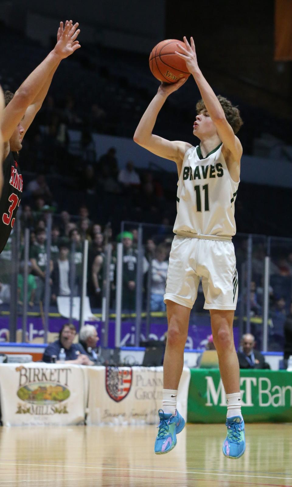 Avon's Trevor Stroud sinks a three point shot in the first half.