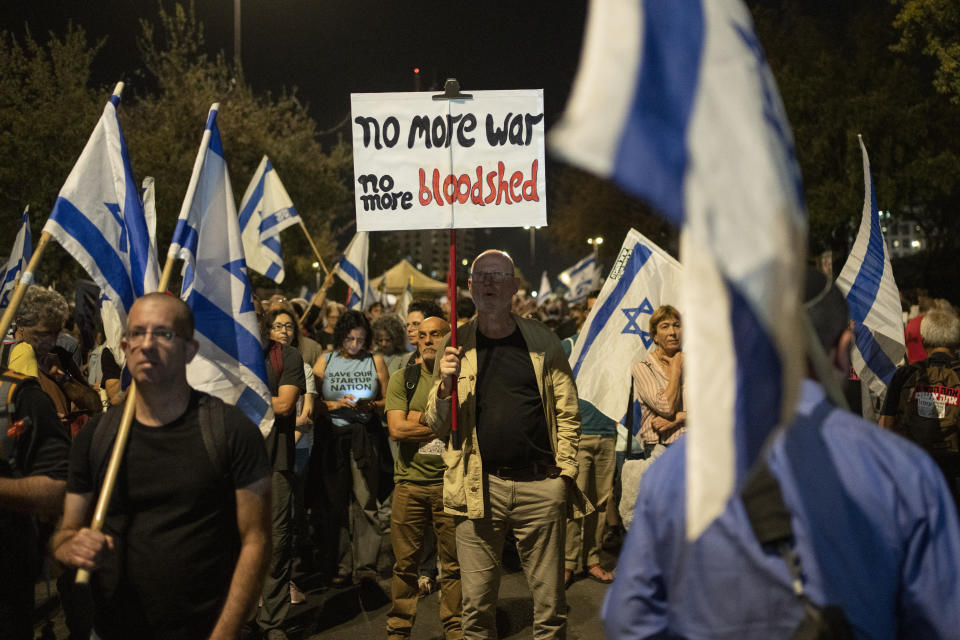 A man holds up a sign during a protest against Israeli Prime Minister Benjamin Netanyahu's government and to call for the release of hostages held in the Gaza Strip by the Hamas militant group near the Knesset, Israel's parliament, in Jerusalem, Monday, April 1, 2024. (AP Photo/Leo Correa)