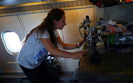 Dominika Pasternak, a Polish PhD student in atmospheric chemistry at Britain's University of York, checks equipment onboard an atmospheric research aircraft en route to the Norwegian Sea from northern Sweden