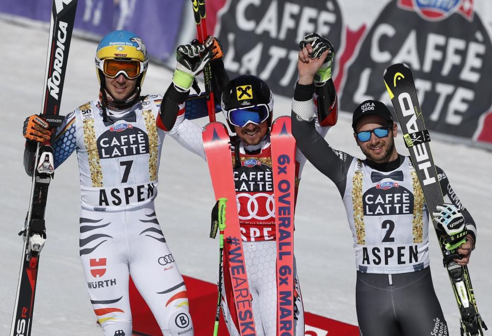 First place finisher Austria's Marcel Hirscher, center, second place finisher Germany's Felix Neureuther, left, and third place finisher France's Mathieu Faivre celebrate after the second run of a men's World Cup giant slalom ski race Saturday, March 18, 2017, in Aspen, Colo. (AP Photo/Brennan Linsley)