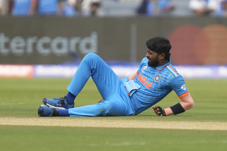 India's Hardik Pandya grimace in pain as he lies on the ground after sustaining an injury during the ICC Men's Cricket World Cup match between India and Bangladesh in Pune, India, Thursday, Oct. 19, 2023. (AP Photo/ Rafiq Maqbool)