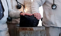 FILE PHOTO: Miners touch the symbolic last piece of stone coal harvested in a German mine to mark the end of coal mining in Germany after it was handed over to German President Frank-Walter Steinmeier at Bellevue palace in Berlin