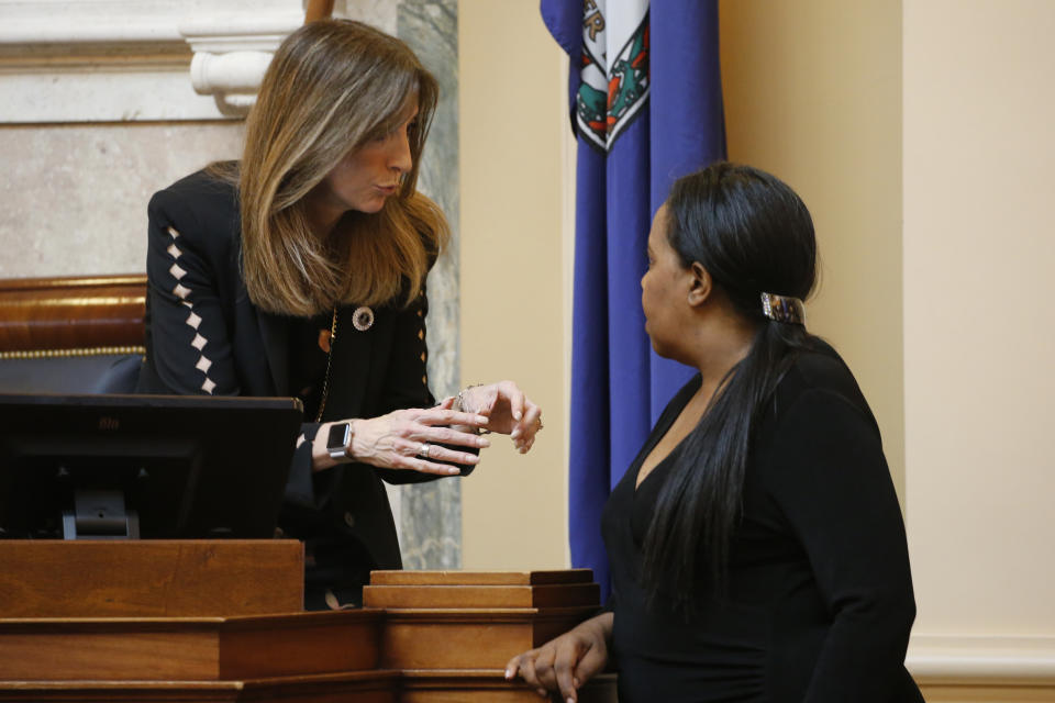 House Speaker Del. Eileen Filler-Corn, D-Fairfax, left, talks with House majority leader Del. Charniele Herring, D-Alexandria, right, during a break in the session at the Capitol Friday March 6 , 2020, in Richmond, Va. (AP Photo/Steve Helber)