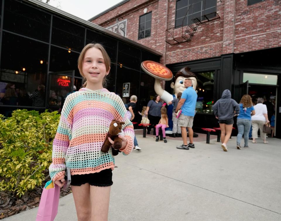 Jenna Teachman, 10, stops for a photo outside of Giuseppe's Steel City Pizza at a benefit auction Friday to help support her treatment for Stage 4 pancreatic cancer. She was diagnosed with the disease this past fall while being treated for a fall from a horse.