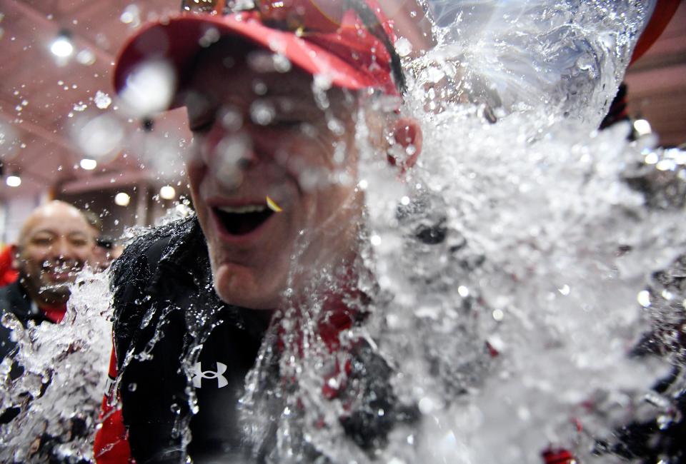 Texas Tech athletes pour water on Texas Tech's director of track and field and cross country Wes Kittley after the men's Big 12 track and field win, Saturday, Feb. 25, 2023, at Sports Performance Center.