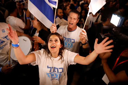 Supporters of Benny Gantz's Blue and White party react to exit polls in Israel's parliamentary election at the party headquarters in Tel Aviv, Israel April 9, 2019. REUTERS/Amir Cohen