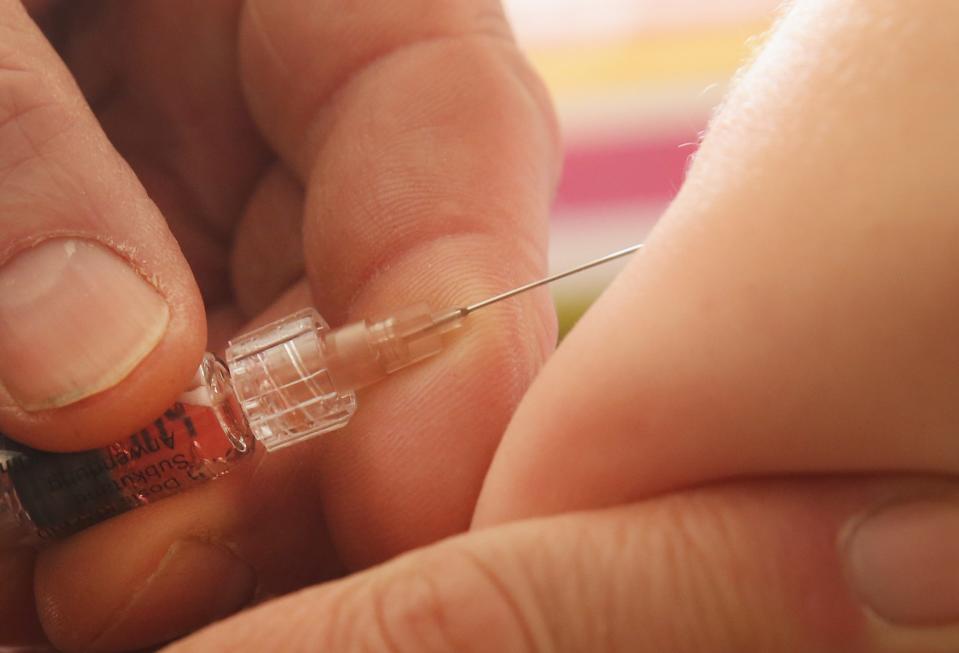 A children's doctor injects a vaccine against measles, rubella, mumps and chicken pox to an infant on Feb. 26, 2015, in Berlin.