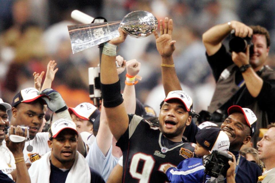 New England Patriots defensive lineman Richard Seymour (93) holds the Vince Lombardi trophy after the Patriots defeated the Carolina Panthers 32-29 to win Super Bowl 38 on Feb. 1, 2004, in Houston.