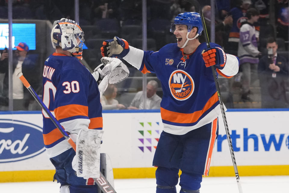 New York Islanders' Scott Mayfield (24) celebrates with goaltender Ilya Sorokin (30) after an NHL hockey game against the Seattle Kraken Tuesday, Feb. 7, 2023, in Elmont, N.Y. The Islanders won 4-0. (AP Photo/Frank Franklin II)