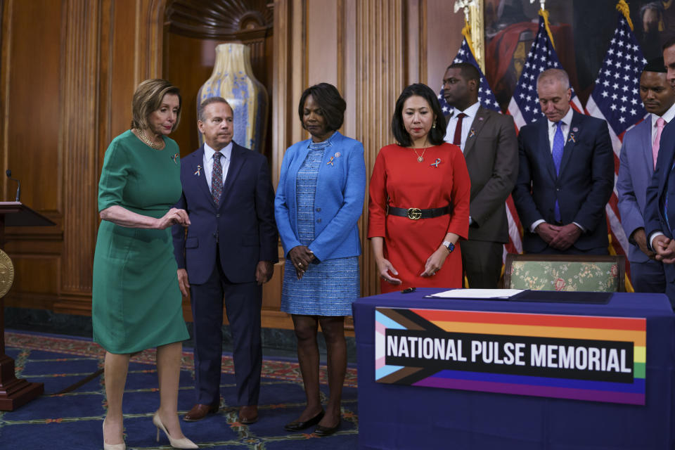 House Speaker Nancy Pelosi, D-Calif., is joins members sign the bill to create the National Pulse Memorial to honor the victims of the 2016 mass shooting at the Pulse nightclub in Orlando, at the Capitol in Washington, Wednesday, June 16, 2021. From left are Rep. David Cicilline, D-R.I., Rep. Val Demings, D-Fla., and Rep. Stephanie Murphy, D-Fla. The shooting was the deadliest attack on the LGBTQ community in U.S. history and left 49 people dead. (AP Photo/J. Scott Applewhite)