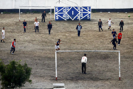 FILE PHOTO: People play football in Pyongyang's suburbs, October 11, 2015. REUTERS/Damir Sagolj/File Photo