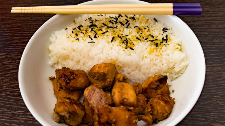 meat and sushi rice on a white plate