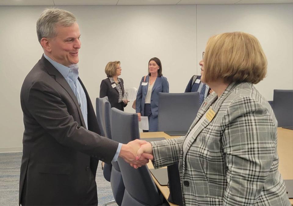 North Carolina Attorney General Josh Stein, left, shakes hands with Henderson County Board of Commissioners Chair Rebecca McCall on Feb. 21 at Blue Ridge Community College. Stein met with leaders of the community to discuss the state's opioid settlement.