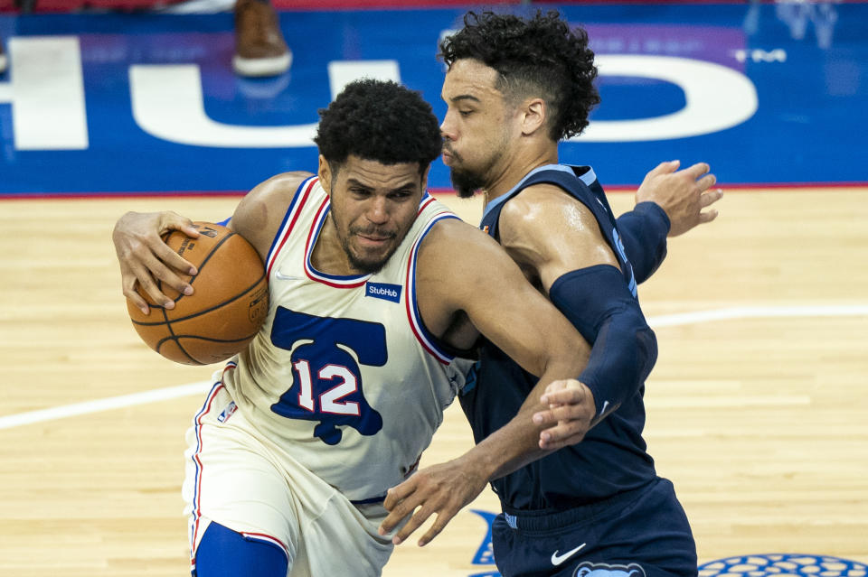 Philadelphia 76ers' Tobias Harris, left, makes his move against Memphis Grizzlies' Dillon Brooks, right, during the first half of an NBA basketball game, Sunday, April 4, 2021, in Philadelphia. (AP Photo/Chris Szagola)