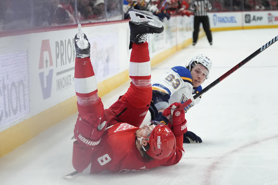 Detroit Red Wings defenseman Ben Chiarot (8) and St. Louis Blues left wing Jake Neighbours (63) collide in the second period of an NHL hockey game Saturday, Feb. 24, 2024, in Detroit. (AP Photo/Paul Sancya)