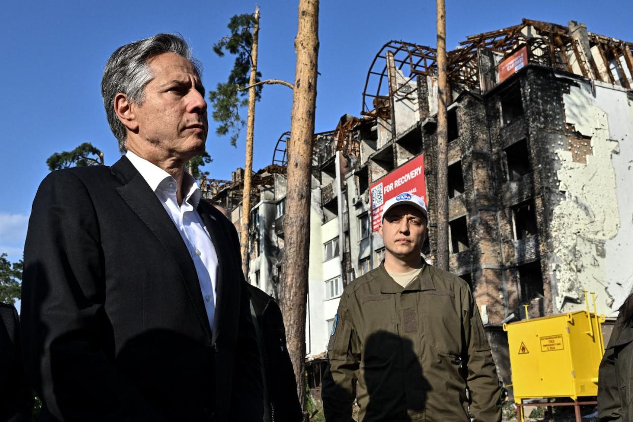 U.S. Secretary of State Antony Blinken, left, stands near a damaged residential building in Irpin, Ukraine, on Sept. 8, 2022. <a href="https://media.gettyimages.com/photos/secretary-of-state-antony-blinken-stands-near-a-damaged-residential-picture-id1243043572" rel="nofollow noopener" target="_blank" data-ylk="slk:Genya Savilov/Pool/AFP via Getty Images;elm:context_link;itc:0;sec:content-canvas" class="link ">Genya Savilov/Pool/AFP via Getty Images </a>