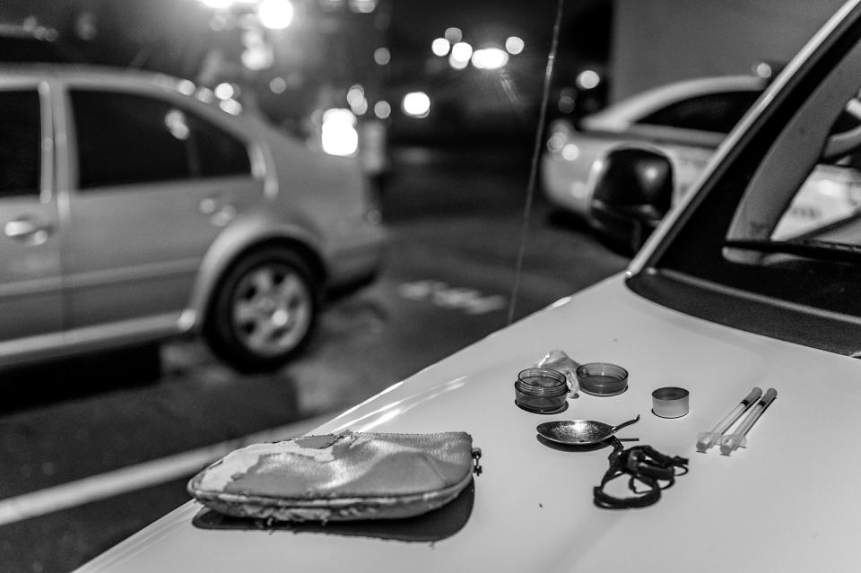 <p>Drug paraphernalia is seen on a car hood as the Middletown Fire Department responds to a call about a woman possibly overdosing on heroin. (Photograph by Mary F. Calvert for Yahoo News) </p>