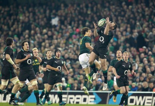 Ireland's wing Tommy Bowe (R) jumps for the ball with South Africa's full back Zane Kirchner during their Autumn International rugby union match at the Aviva stadium in Dublin. Ireland let slip a 12-3 half-time lead to lose their one-off test with South Africa, who turned things round to win 16-12