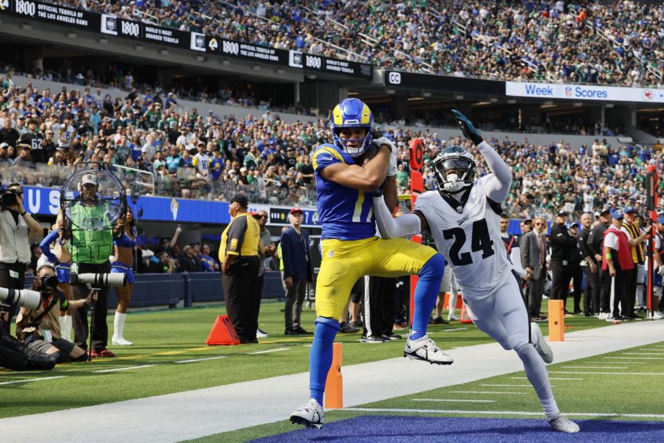 Rams receiver Puka Nacua catches a touchdown pass as Eagles corner James Bradberry tries to defend.