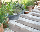 <p> If you’re after that super-smart coastal vibe for your budget backyard, consider using timber decking boards or planks, laying them horizontally to create a cheap DIY garden path. If you want to add interest, you can edge the decking or planks with lines of gravel or pebbles.  </p> <p> This boardwalk style of path can also be super practical; a wheelbarrow will have no problem navigating a decking path.  </p> <p> 'Decking boards are easy to lay and are a cost-effective solution to creating a path in your outdoor space,' says Rowan Cripps, owner of landscaping company Infinite Paving. 'If you choose a lighter wood, you also bring some light to the garden. Also, hardwood decking is a sturdy material which will withstand a lot of hammer.' </p>