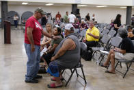 Family members of a shooting victim, who did not wish to share their names, and friends attend a city council meeting, Tuesday, July 12, 2022, in Uvalde, Texas. A Texas lawmaker says surveillance video from the school hallway at Robb Elementary School where police waited as a gunman opened fire in a fourth-grade classroom will be shown this weekend to residents of Uvalde. (AP Photo/Eric Gay)