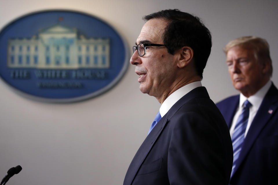 FILE - In this April 21, 2020, file photo President Donald Trump listens as Treasury Secretary Steven Mnuchin speaks about the coronavirus in the James Brady Press Briefing Room of the White House in Washington. Some of Trump’s top economic advisers emphasized on Sunday, May 10, the importance of states getting more businesses and offices open. (AP Photo/Alex Brandon, File)