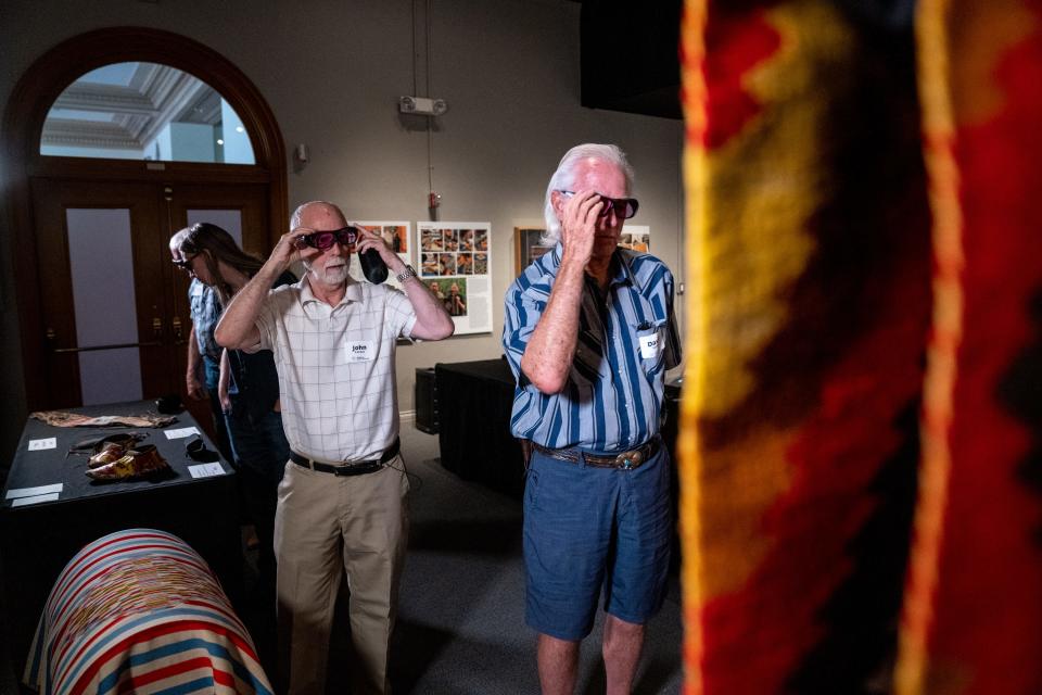 John Turner (left), David Eerkes (right) and other people with color blindness wear EnChroma glasses during a demonstration of the technology at the Arizona State Museum located at the University of Arizona in Tucson on Sept. 19, 2023.