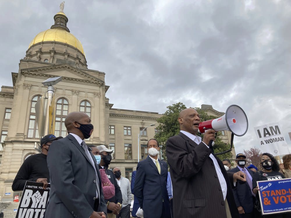 In this March 25, 2021, file photo African Methodist Episcopal Church Bishop Reginald Jackson announces a boycott of Coca-Cola Co. products outside the Georgia Capitol in Atlanta. (AP Photo/Jeff Amy, File)