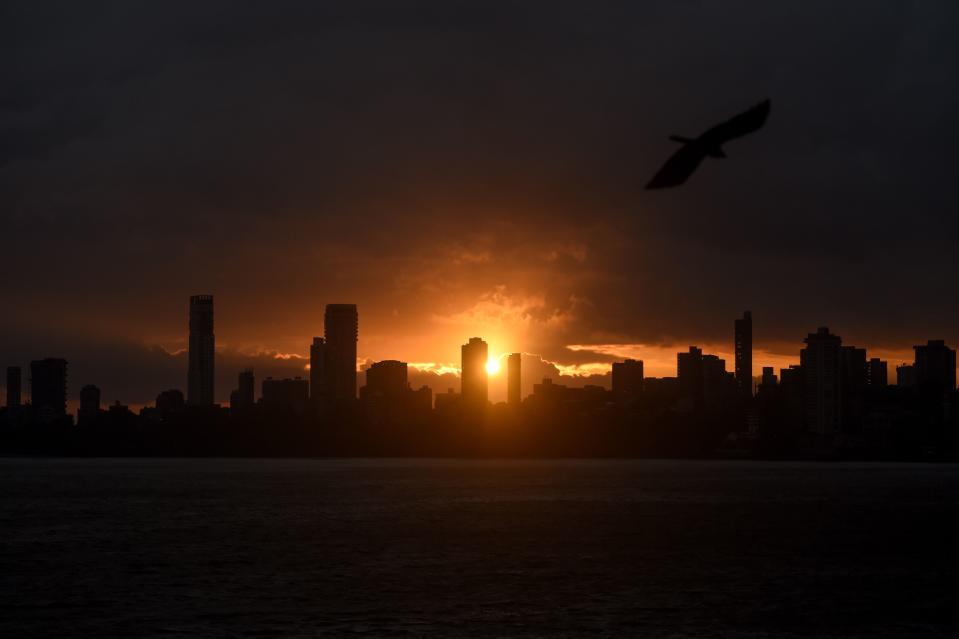 A general view shows clouds lingering over the city's skyline during the sunset in Mumbai on June 3, 2020, as cyclone Nisarga barrels towards India's western coast. - Mumbai authorities shut offices, banned small gatherings and told people to stay home on June 3 as the Indian megacity's first cyclone in more than 70 years approached. Cyclone Nisarga was expected to make landfall near the coastal town of Alibag, around 100 kilometres (60 miles) south of Mumbai, on June 3 afternoon, forecasters said. (Photo by Punit PARANJPE / AFP) (Photo by PUNIT PARANJPE/AFP via Getty Images)