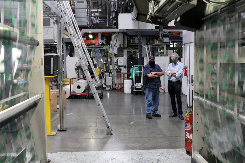 FILE PHOTO: Emerald Packaging CEO Kevin Kelly speaks with employee during coronavirus pandemic