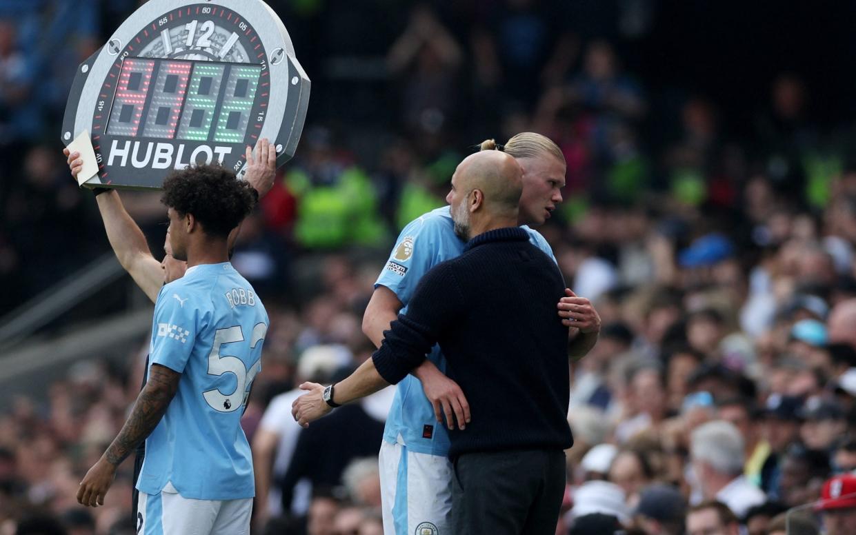 Erling Haaland embraces Pep Guardiola as he comes off
