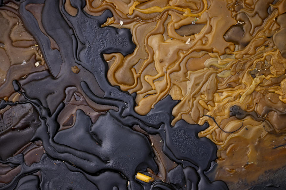 Melted wax from candles lit during a memorial near the site of a mass shooting outside Vladislav Ribnikar school in Belgrade, Serbia, Saturday, May 6, 2023. A 13-year-old boy, on Wednesday, used his father's guns to kill eight fellow students and a guard. (AP Photo/Armin Durgut)