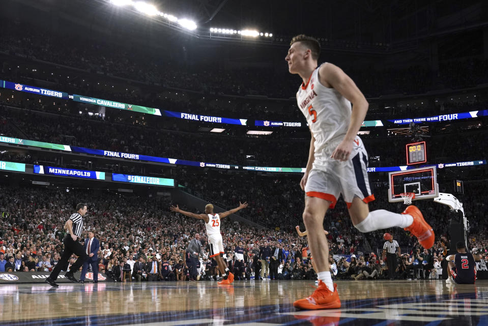 Virginia's Mamadi Diakite, left, and Kyle Guy, right, celebrate at the end of a semifinal round game against Auburn in the Final Four NCAA college basketball tournament, Saturday, April 6, 2019, in Minneapolis. (AP Photo/David J. Phillip)