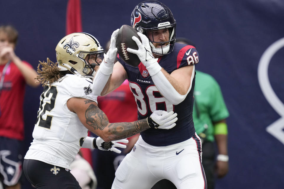 Houston Texans tight end Dalton Schultz (86) pulls in a touchdown pass against New Orleans Saints safety Tyrann Mathieu (32) in the first half of an NFL football game in Houston, Sunday, Oct. 15, 2023. (AP Photo/Eric Christian Smith)