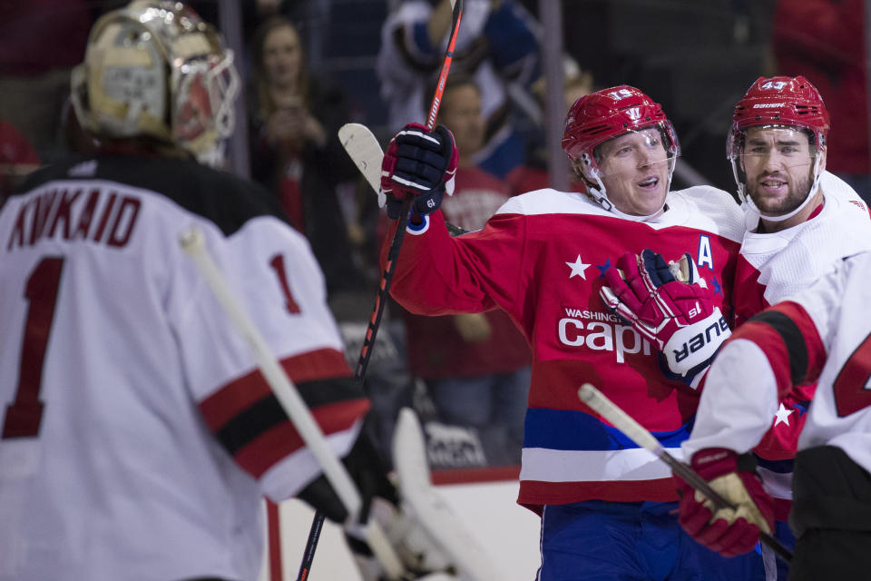 New Jersey Devils goaltender Keith Kinkaid (1) watches as Washington Capitals center Nicklas Backstrom (19), from Sweden, and right wing Tom Wilson (43) celebrate a goal by Backstrom during the first period of an NHL hockey game, Friday, Nov. 30, 2018, in Washington. (AP Photo/Alex Brandon)