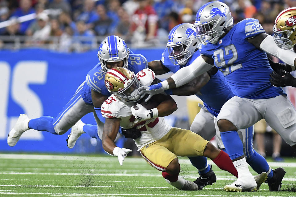 San Francisco 49ers running back Elijah Mitchell (25) is brought down by Detroit Lions cornerback Jeff Okudah (23) in the second half of an NFL football game in Detroit, Sunday, Sept. 12, 2021. (AP Photo/Lon Horwedel)
