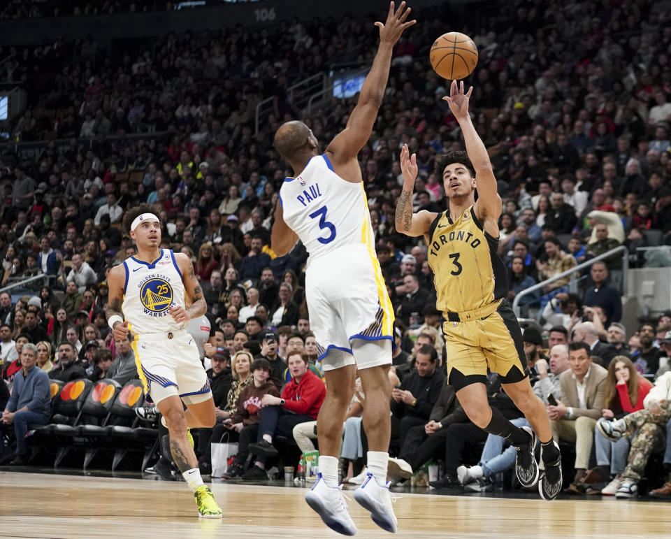 Toronto Raptors guard D.J. Carton, right, shoots while Golden State Warriors guard Chris Paul, center, defends during the second half of an NBA basketball game in Toronto, Friday, March 1, 2024. (Arlyn McAdorey/The Canadian Press via AP)