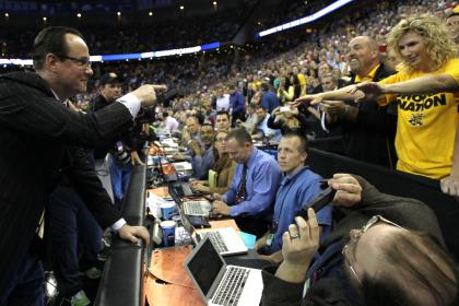 Gregg Marshall celebrates with a fan after beating Kansas in the NCAA tournament Round of 32. (Getty)