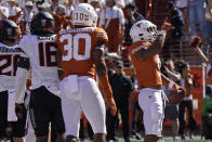 Texas running back Bijan Robinson (5) celebrates his touchdown run against Oklahoma State during the first half of an NCAA college football game in Austin, Texas, Saturday, Oct. 16, 2021. (AP Photo/Chuck Burton)