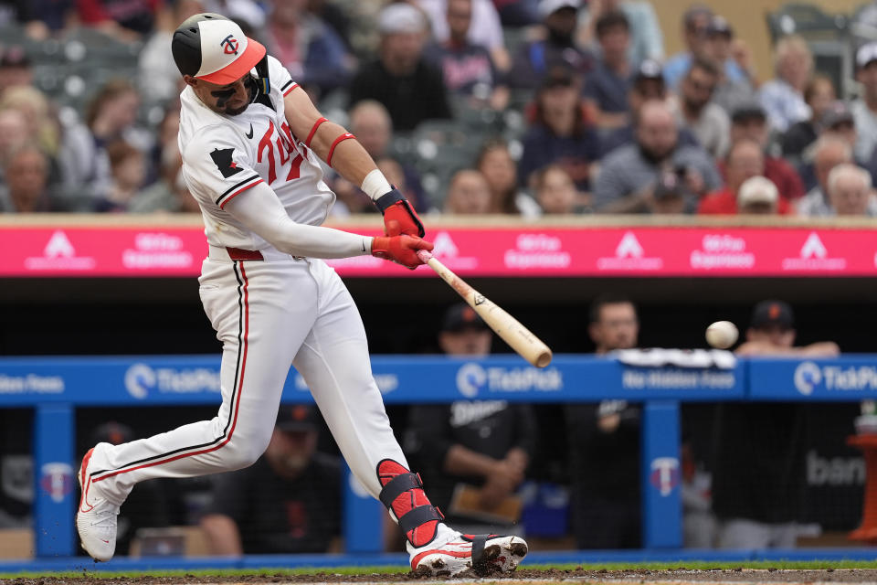 Minnesota Twins' Royce Lewis hits a two-run double during the third inning of a baseball game against the Detroit Tigers, Tuesday, July 2, 2024, in Minneapolis. (AP Photo/Abbie Parr)