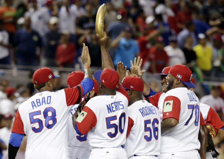 Dominican Republic pitcher Hector Neris (50) holds up a replica of a plantain after the Dominican Republic defeated Canada 9-2 in a first-round game of the World Baseball Classic, Thursday, March 9, 2017, in Miami. (AP Photo/Lynne Sladky)