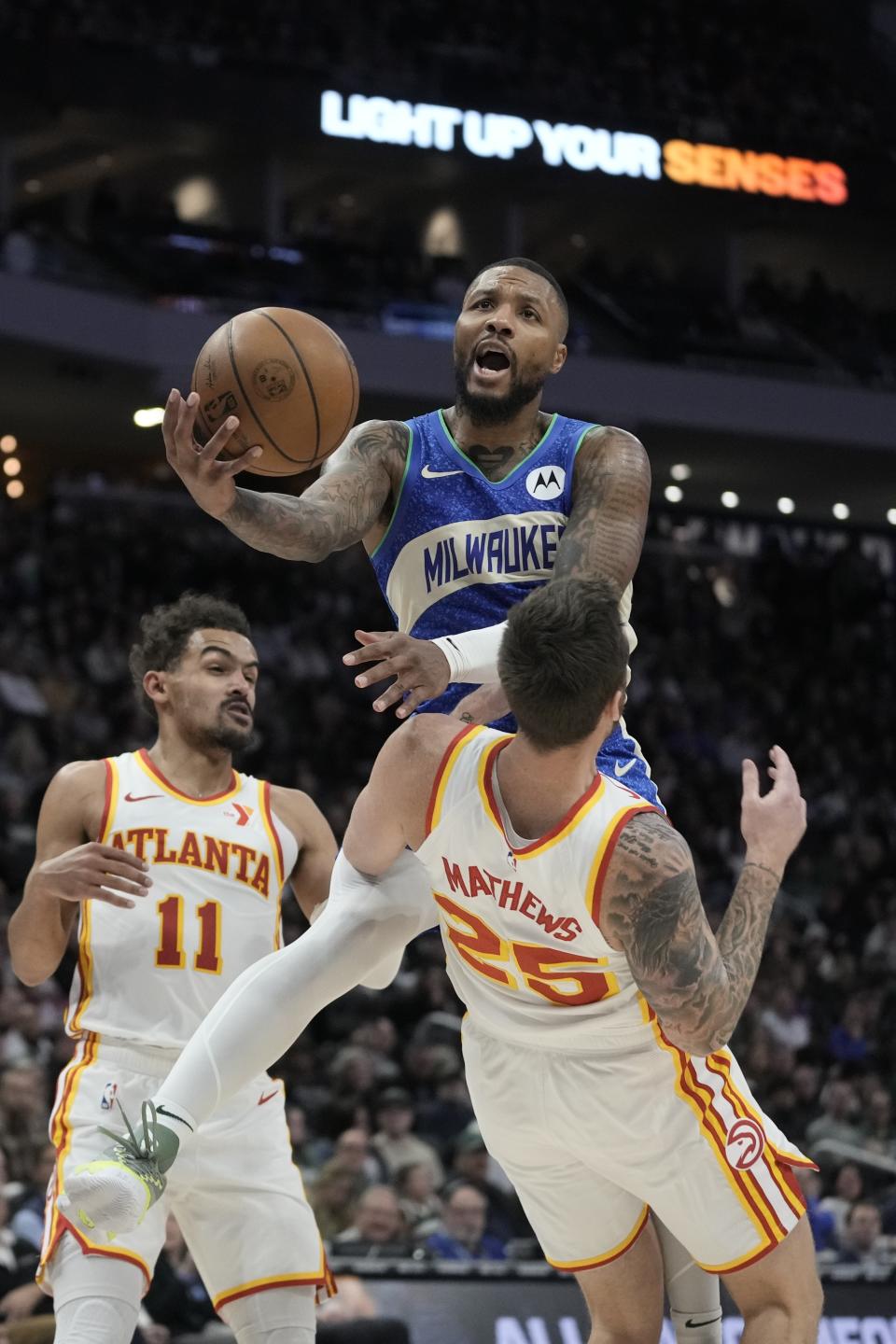 Milwaukee Bucks' Damian Lillard is called for a charge on Atlanta Hawks' Garrison Mathews during the second half of an NBA basketball game Saturday, Dec. 2, 2023, in Milwaukee. The Bucks won 132-121. (AP Photo/Morry Gash)