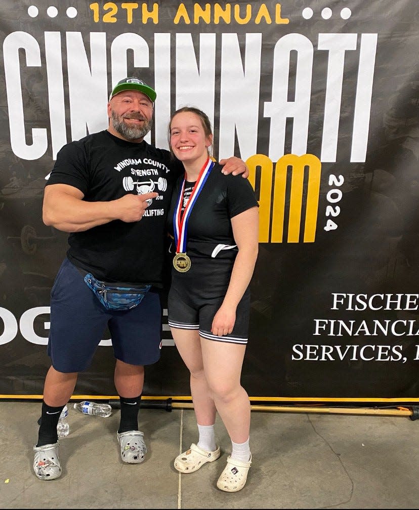 Killingly High School senior Sherrie Simoneau (right) poses with her powerlifting coach Mike Behrle (left) at the 2024 IPA Cincinnati Women's Pro/Am.